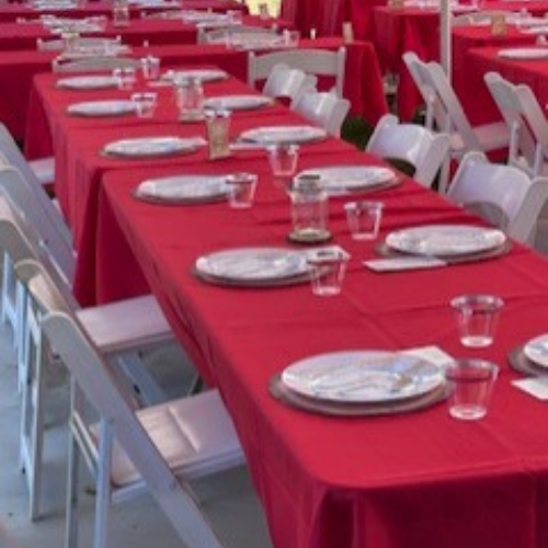 Chairs, tables and plateware set up for a wedding venue