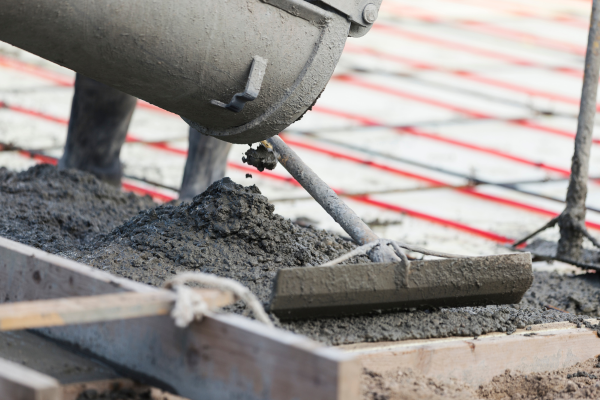 Concrete being poured and leveled.