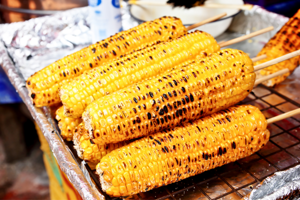 A stack of grilled corn on the cobb.