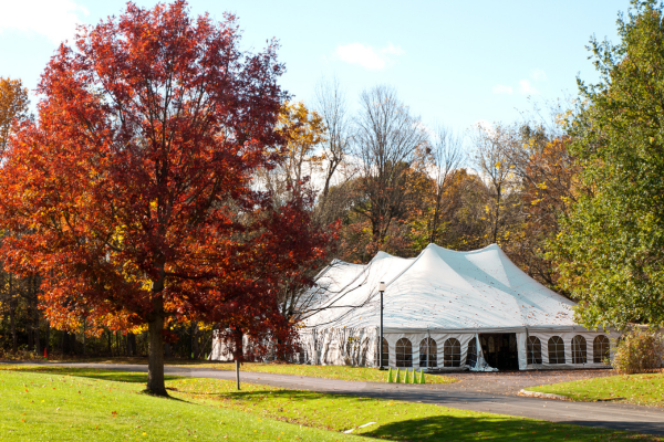 A white party tent setup outdoors.