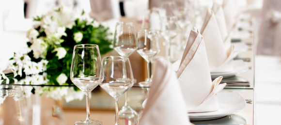 A banquet table fully set with plateware.